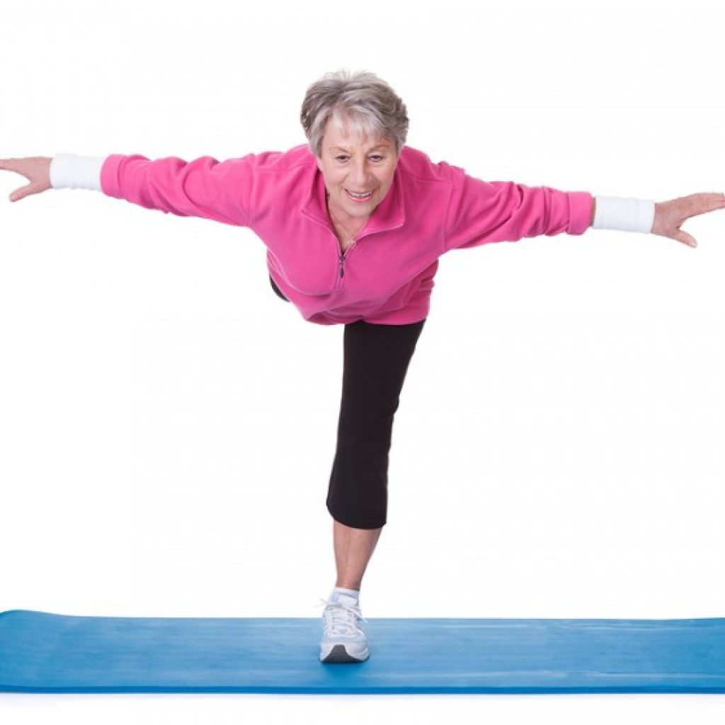 senior woman standing on one leg