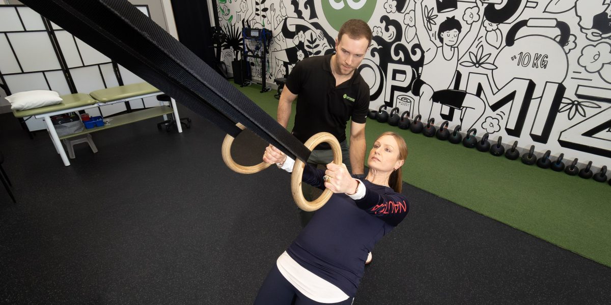 Woman strength training with a personal trainer
