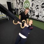 Woman strength training with a personal trainer